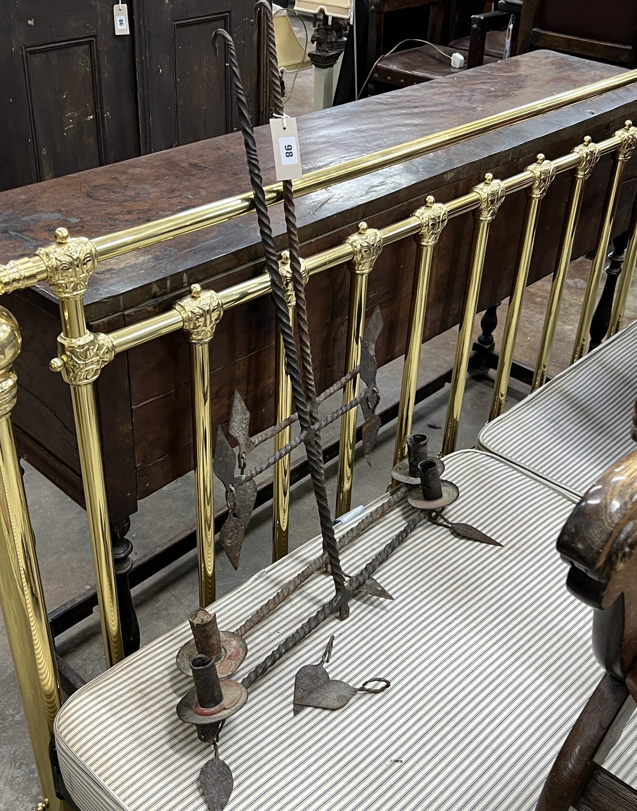A pair of wrought iron hanging candle holders, width 64cm, height 82cm